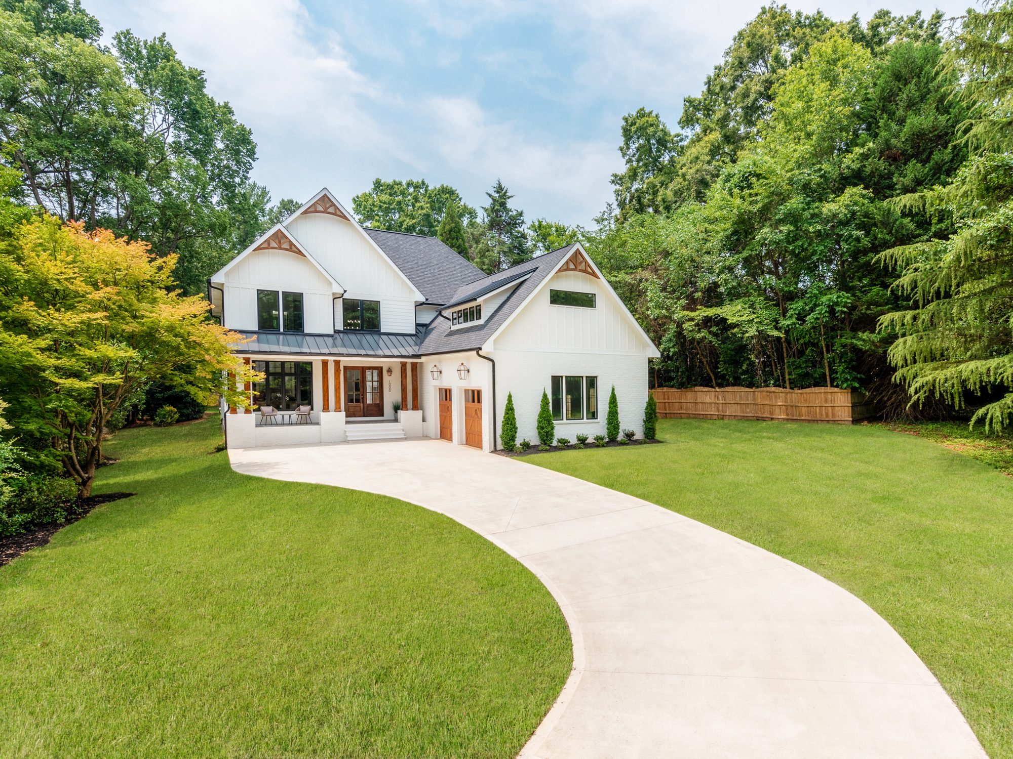 Three-quarter view of Brantham showing the porch, gables, and circular driveway — Stillman Properties Charlotte NC