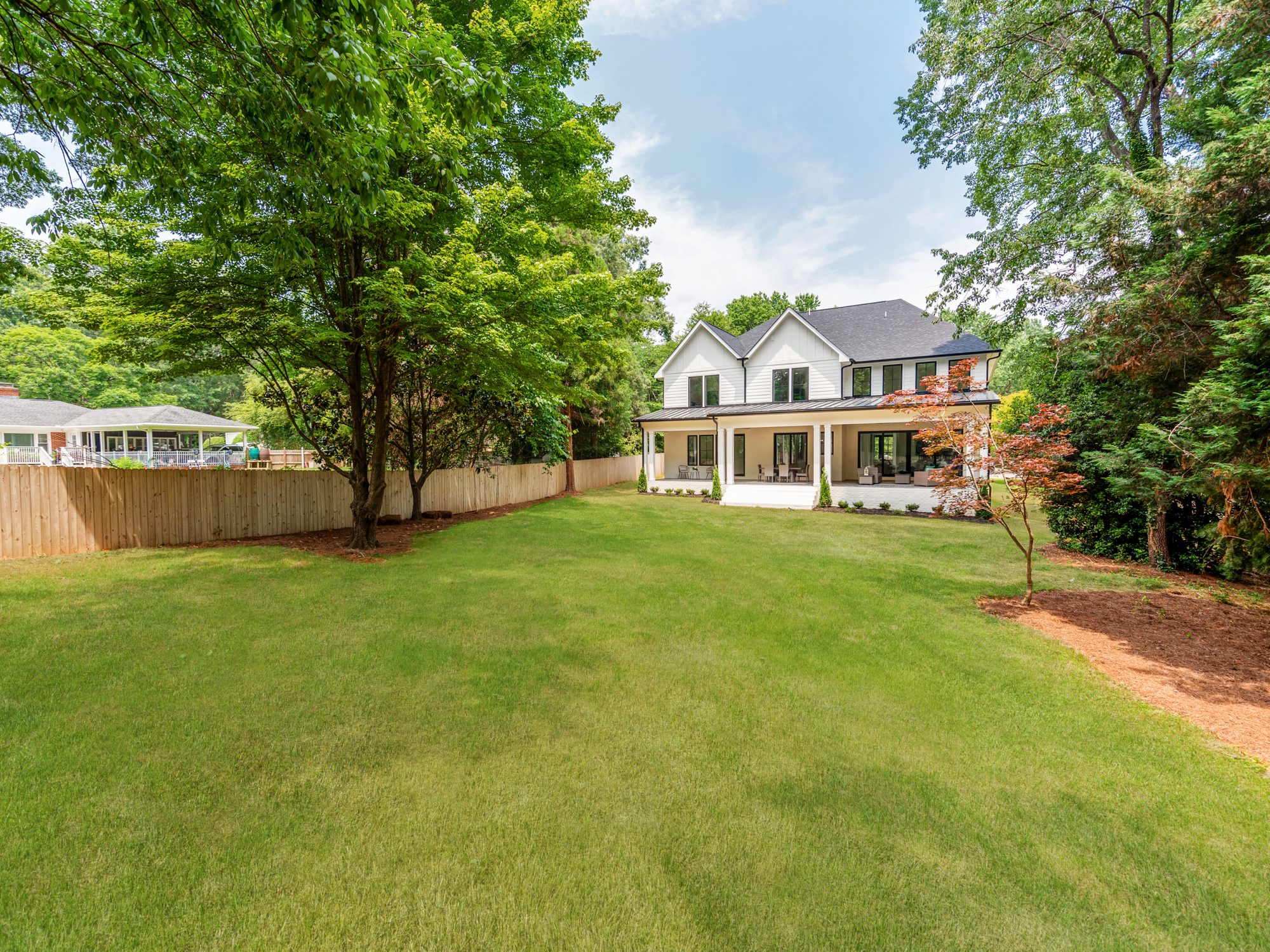 Wide property view of Brantham showing the front lawn and full elevation — Stillman Properties Charlotte NC