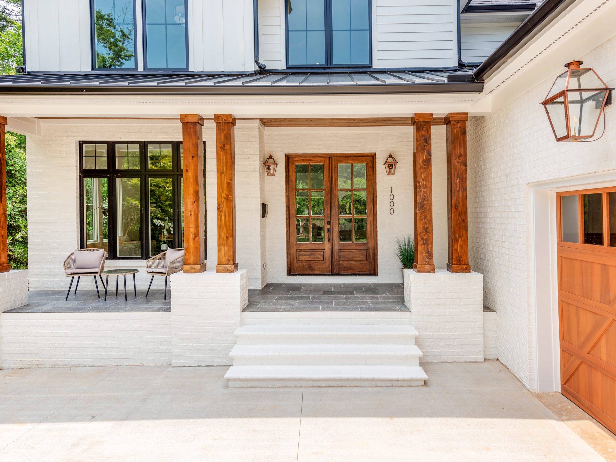 Front entry approach with covered porch and double doors — Brantham modern farmhouse by Stillman Properties Charlotte NC
