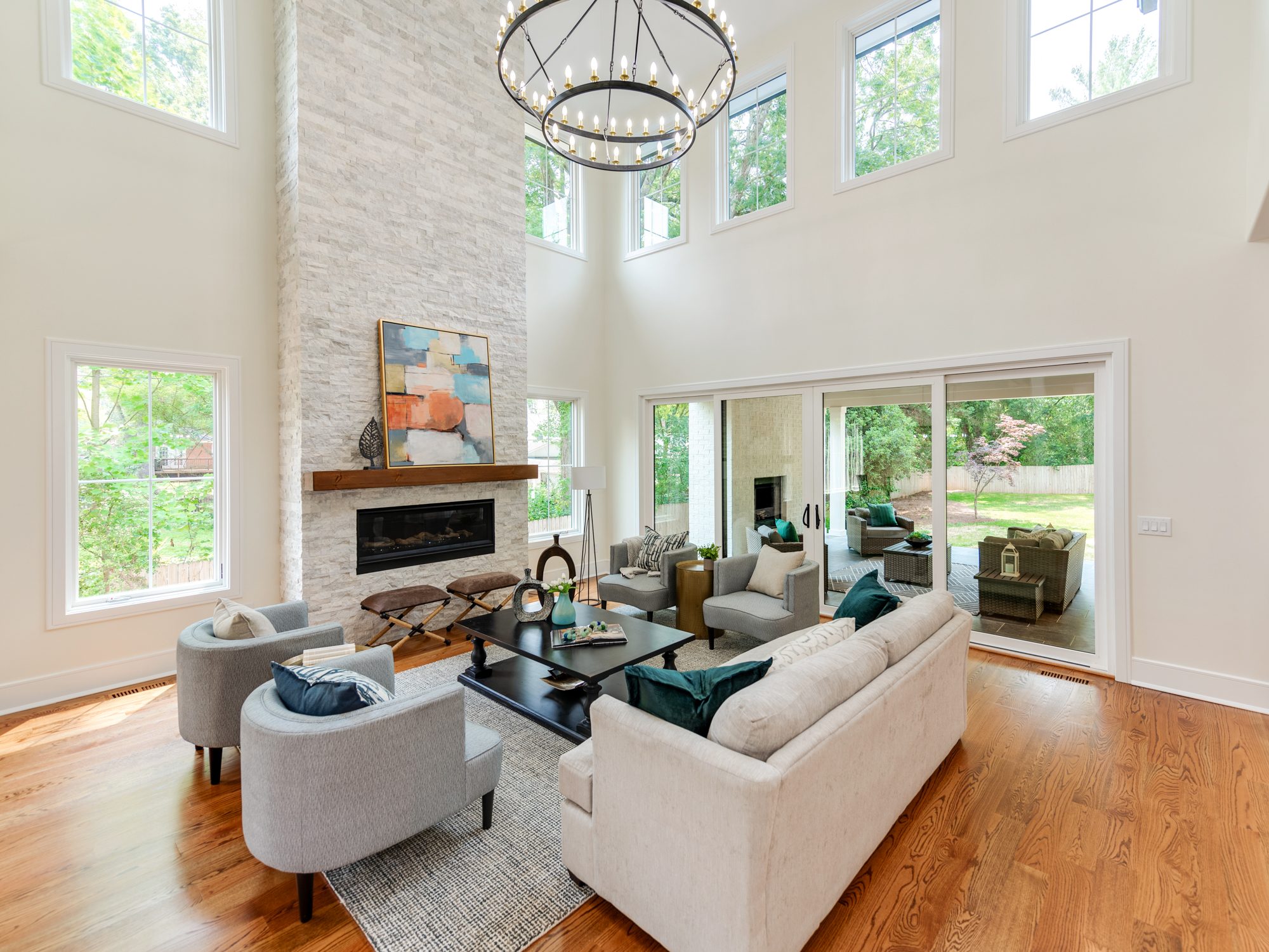 Great room with limestone fireplace and built-in flanking shelving — Brantham by Stillman Properties Charlotte NC