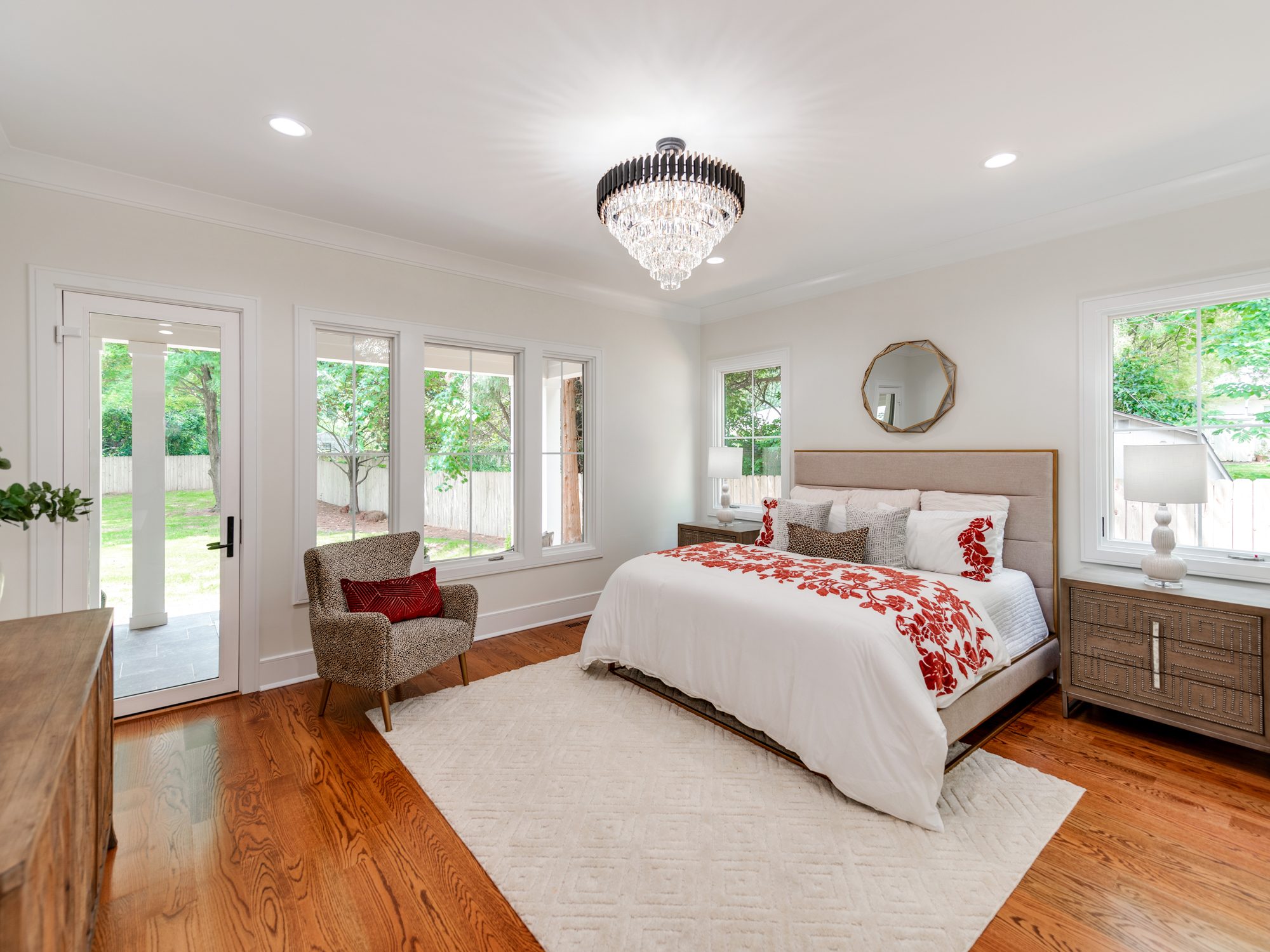 Primary bedroom with crystal chandelier and French doors to the yard — Brantham by Stillman Properties Charlotte NC