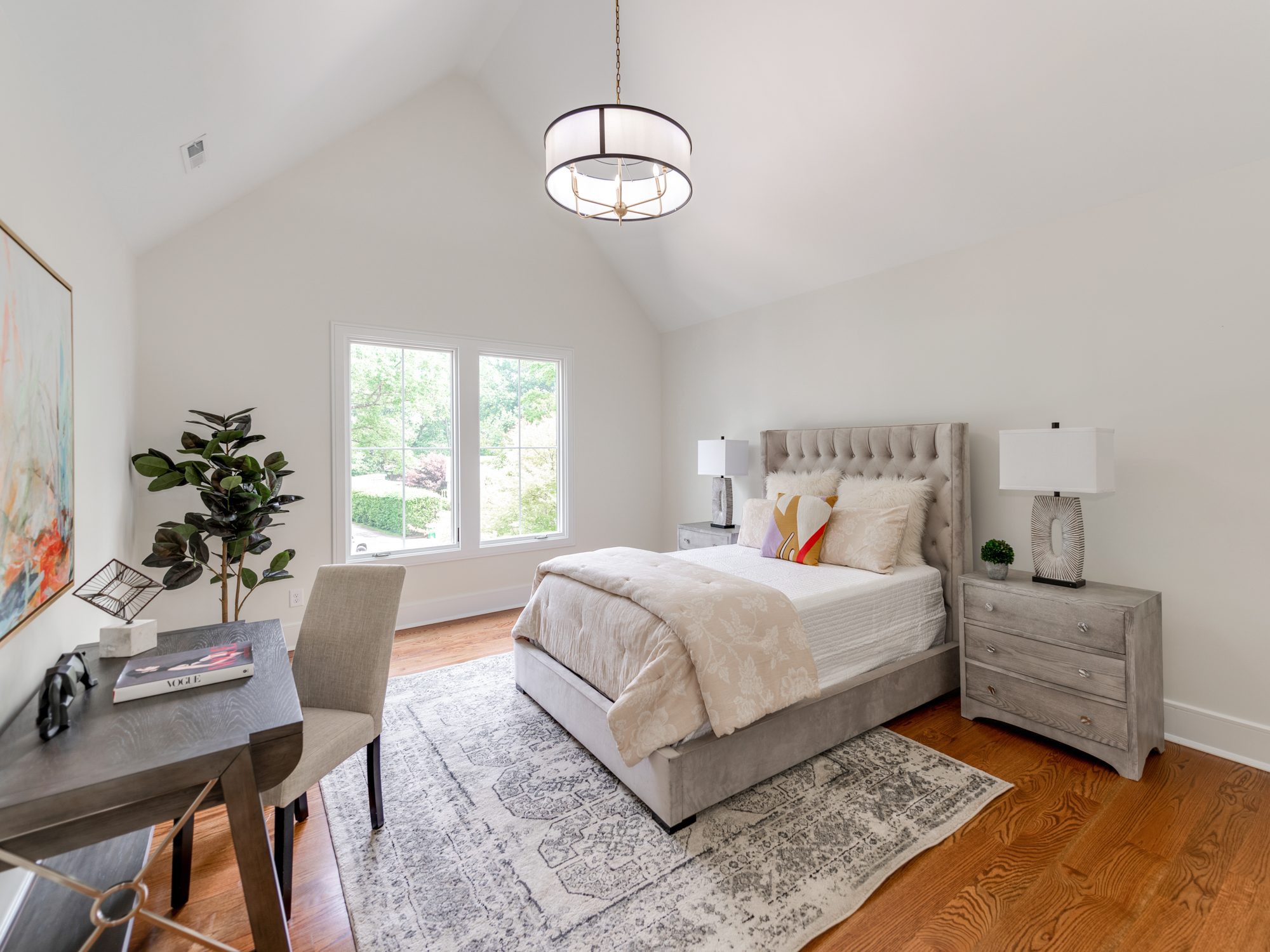 Guest bedroom with vaulted ceiling and tufted upholstered bed — Brantham by Stillman Properties Charlotte NC
