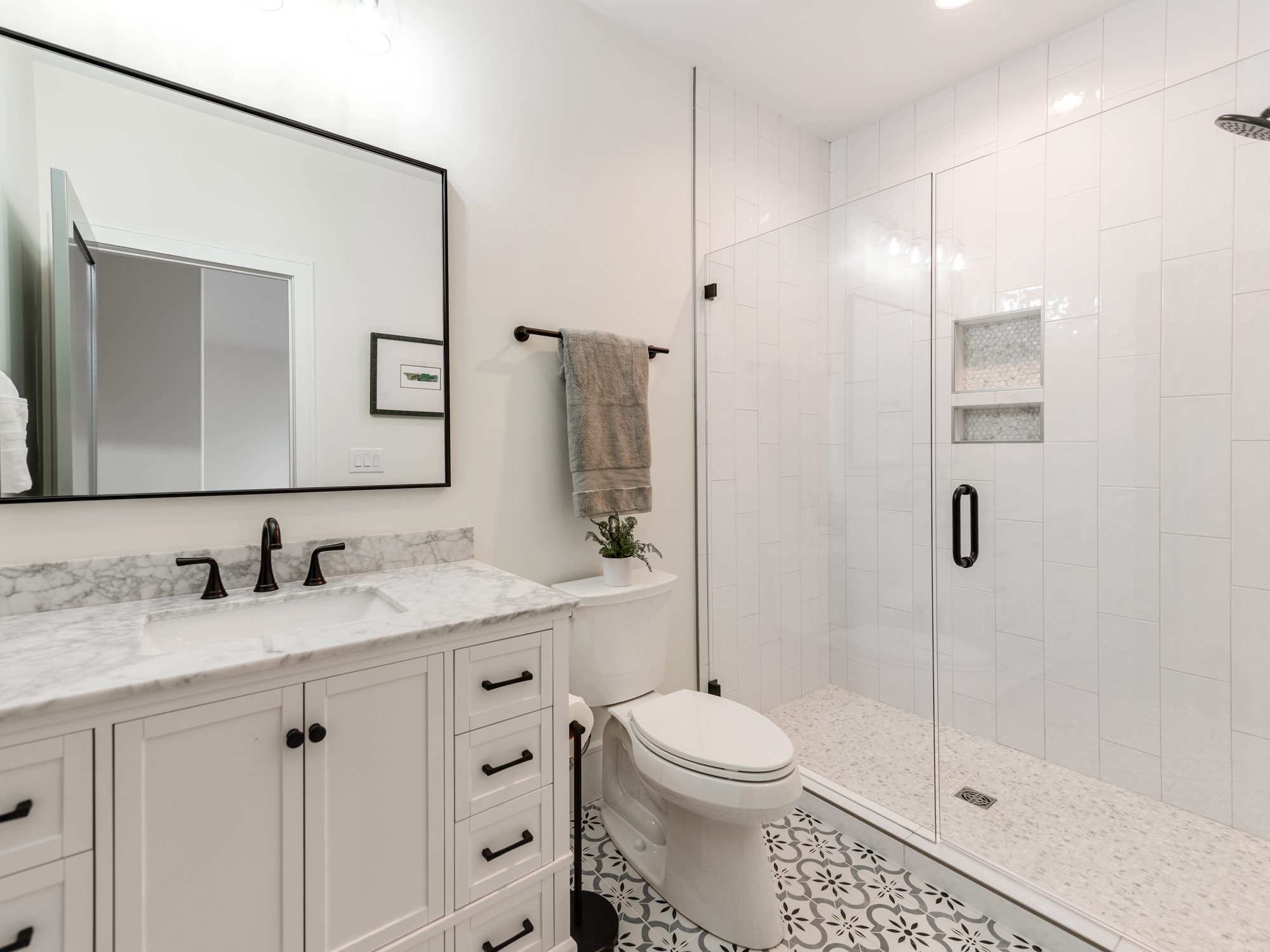 Guest bath with glass shower enclosure and tile detailing — Brantham by Stillman Properties Charlotte NC