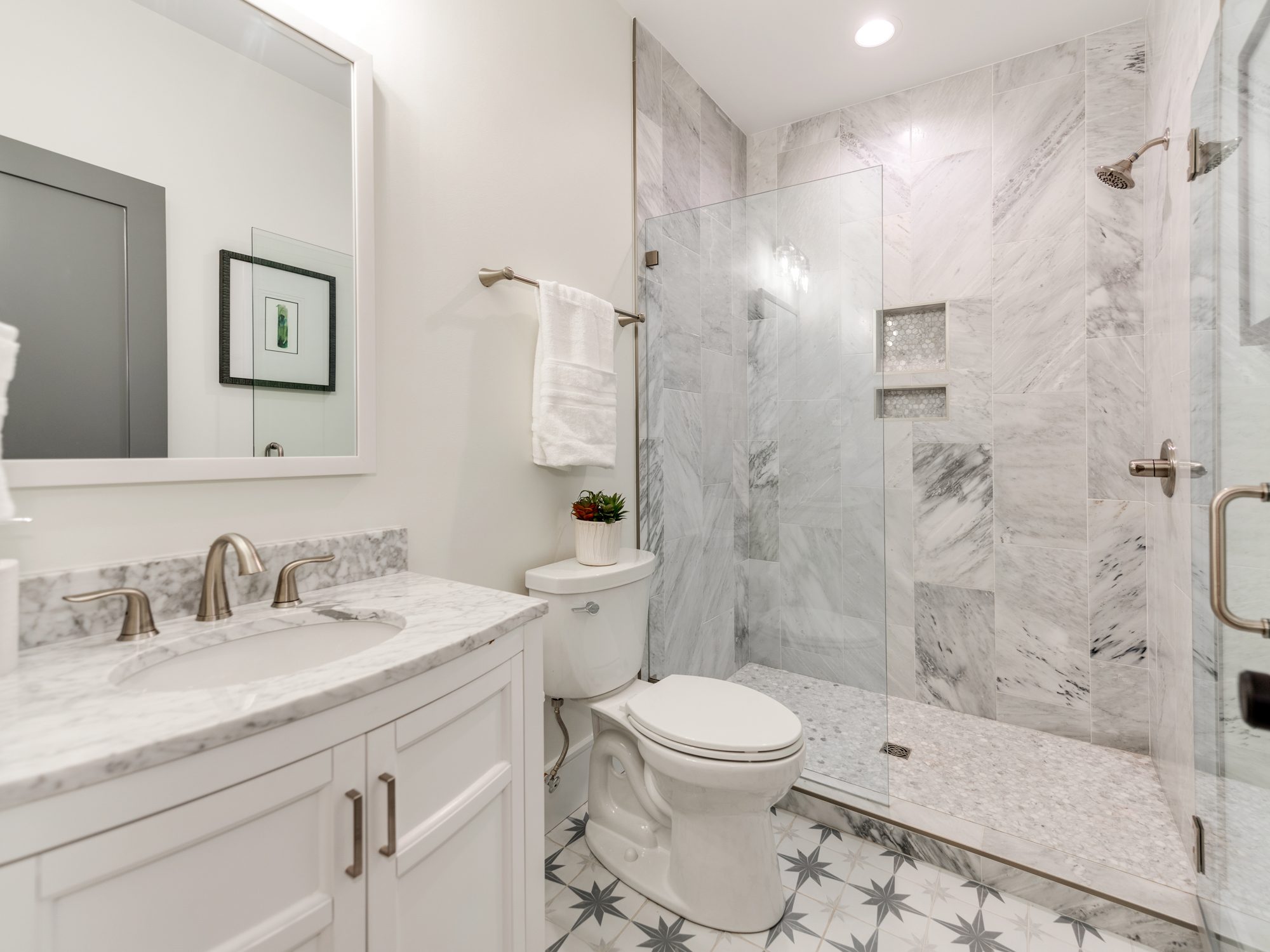Guest bath with marble accents and double mirror layout — Brantham by Stillman Properties Charlotte NC