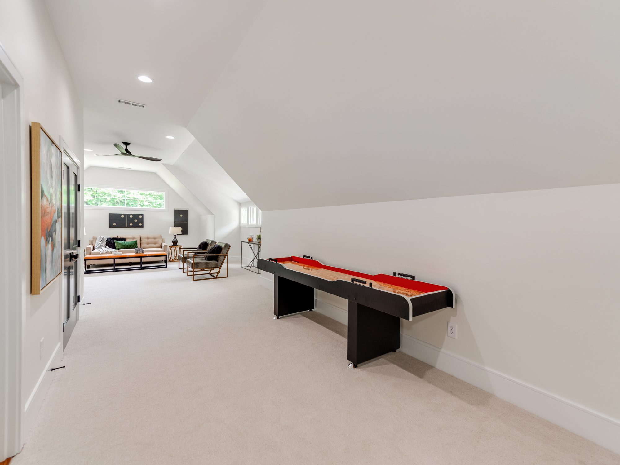Bonus room shuffleboard table beneath vaulted ceiling — Brantham by Stillman Properties Charlotte NC