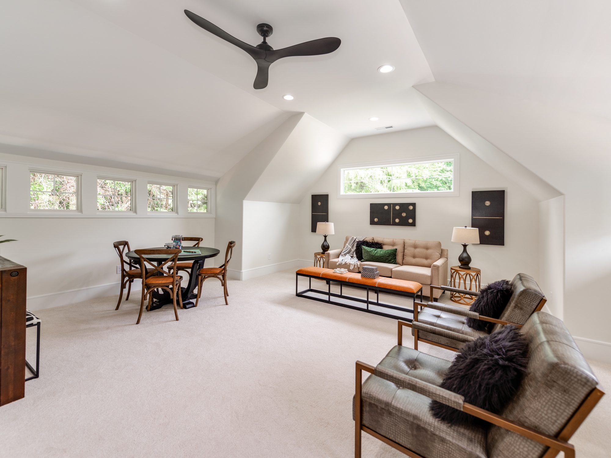 Upstairs bonus room with vaulted ceiling, shuffleboard table, and lounge seating — Brantham by Stillman Properties Charlotte NC