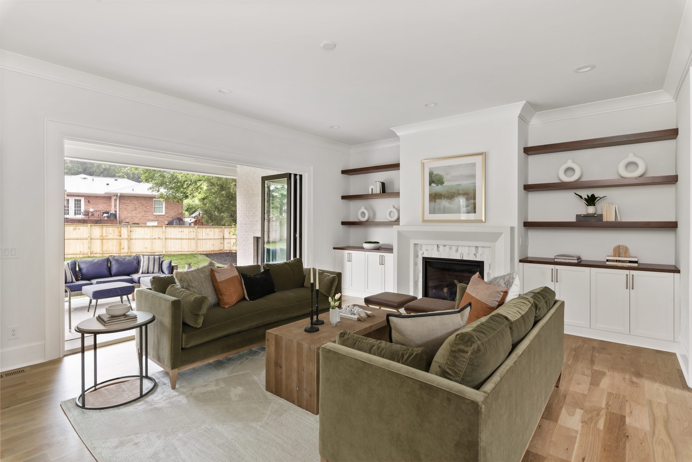 Great room looking toward the covered porch through sliding glass doors — Bywood by Stillman Properties Charlotte NC