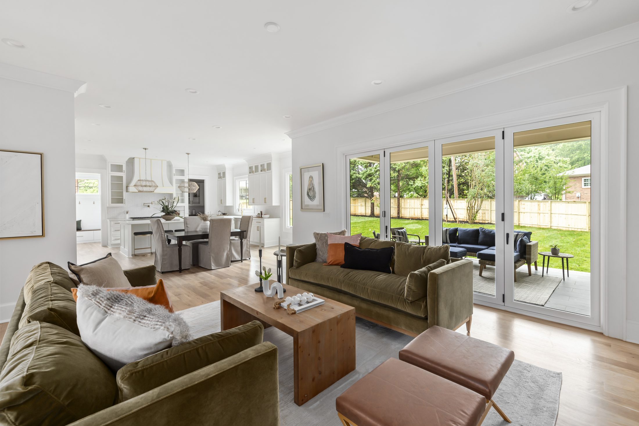 Great room from an alternate angle showing velvet sofas open to the kitchen — Bywood by Stillman Properties Charlotte NC