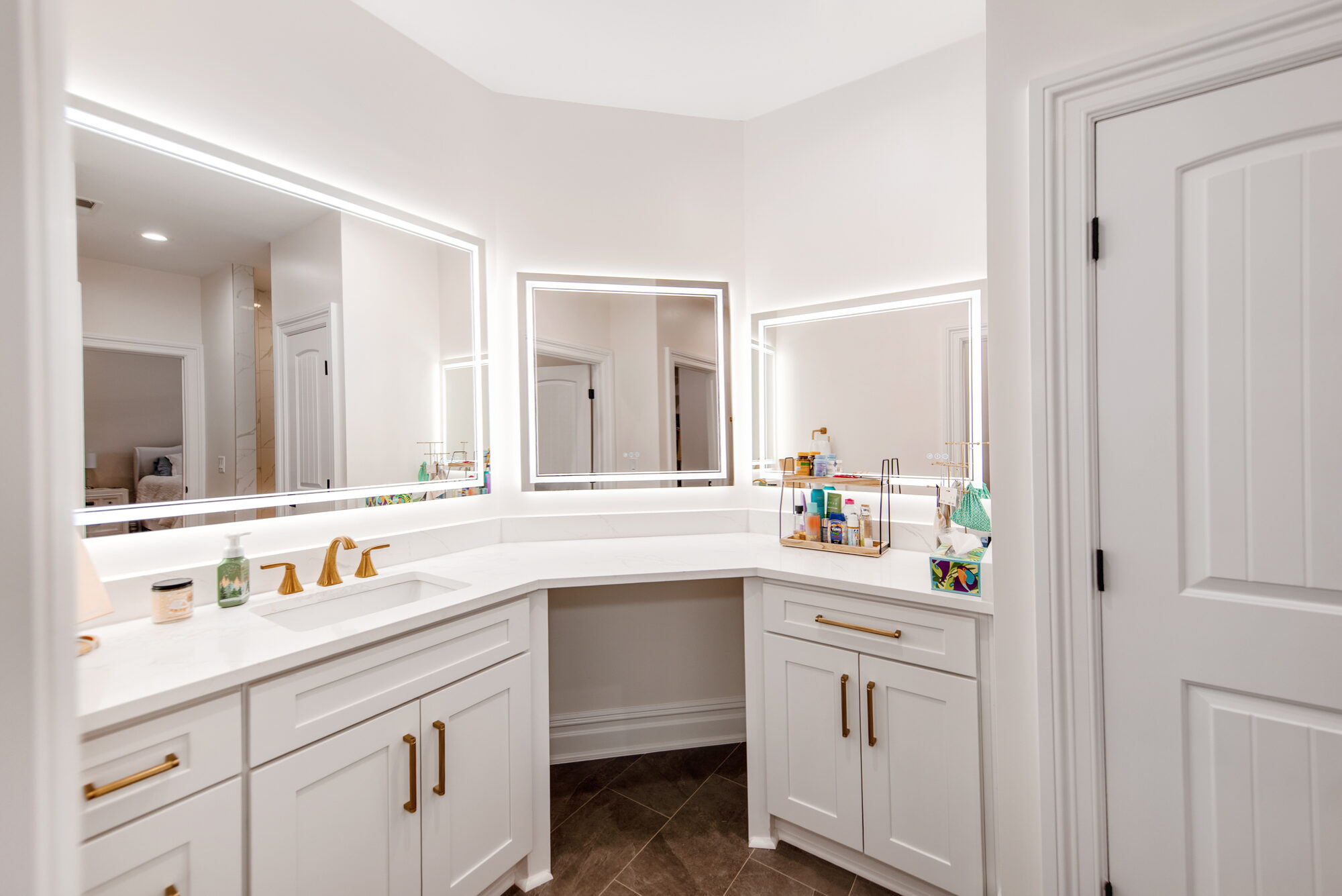 Guest bath corner vanity with paired LED mirrors and quartz waterfall edge — Coddle Creek by Stillman Properties Concord NC
