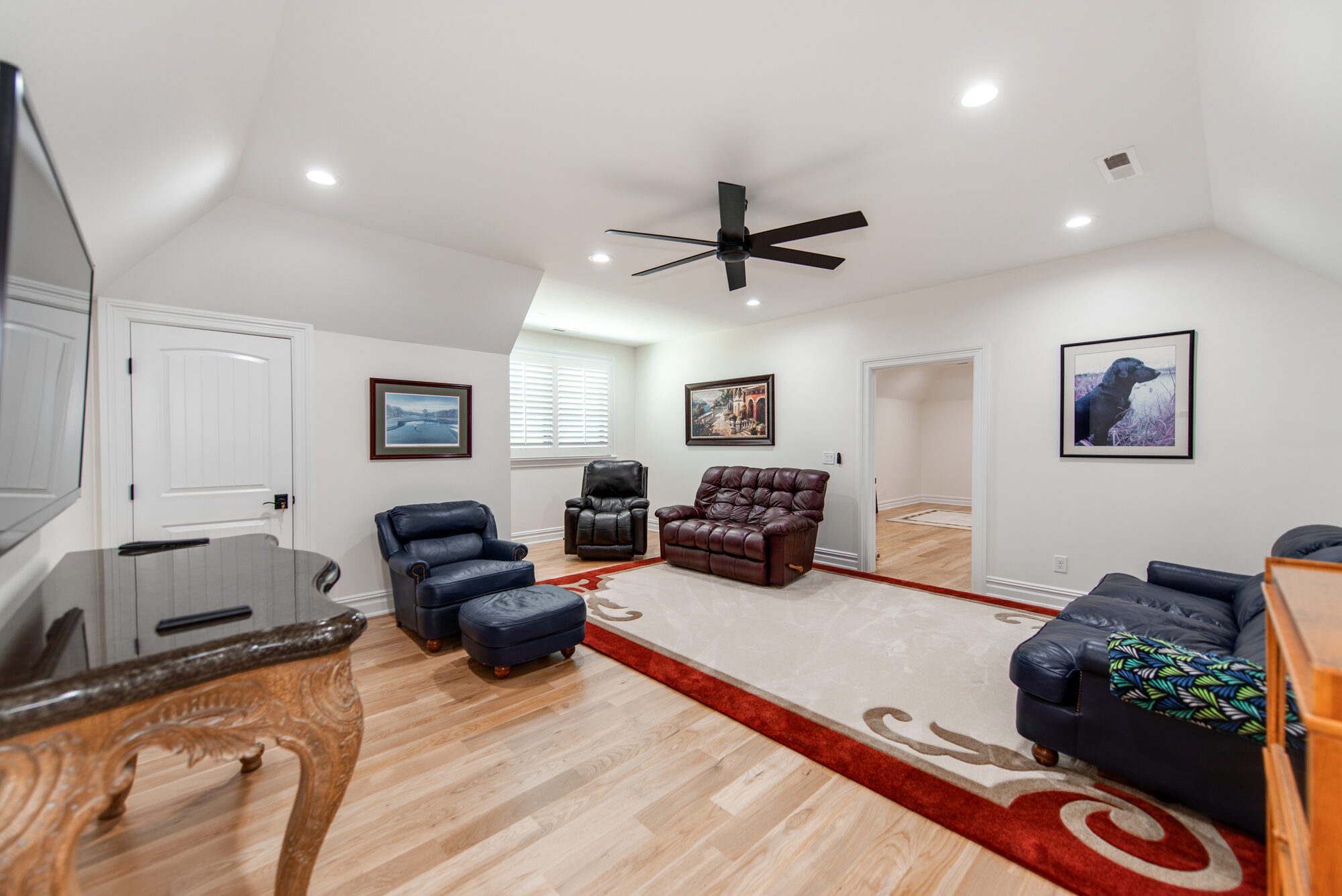 Upstairs media and bonus room with vaulted ceiling and dedicated lounge seating — Coddle Creek by Stillman Properties Concord NC