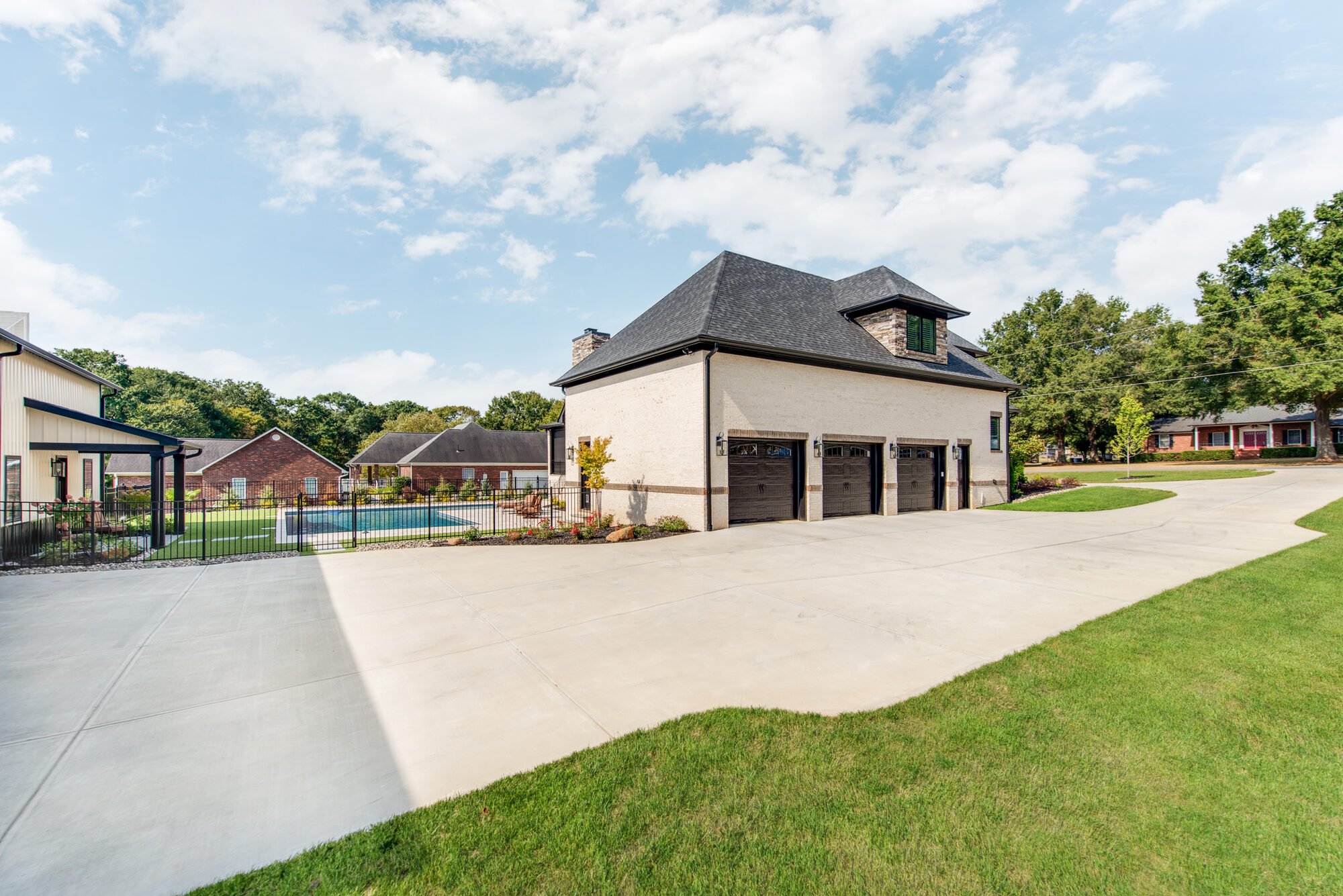 Side view from pool deck looking toward main house and barndominium — Coddle Creek by Stillman Properties Concord NC