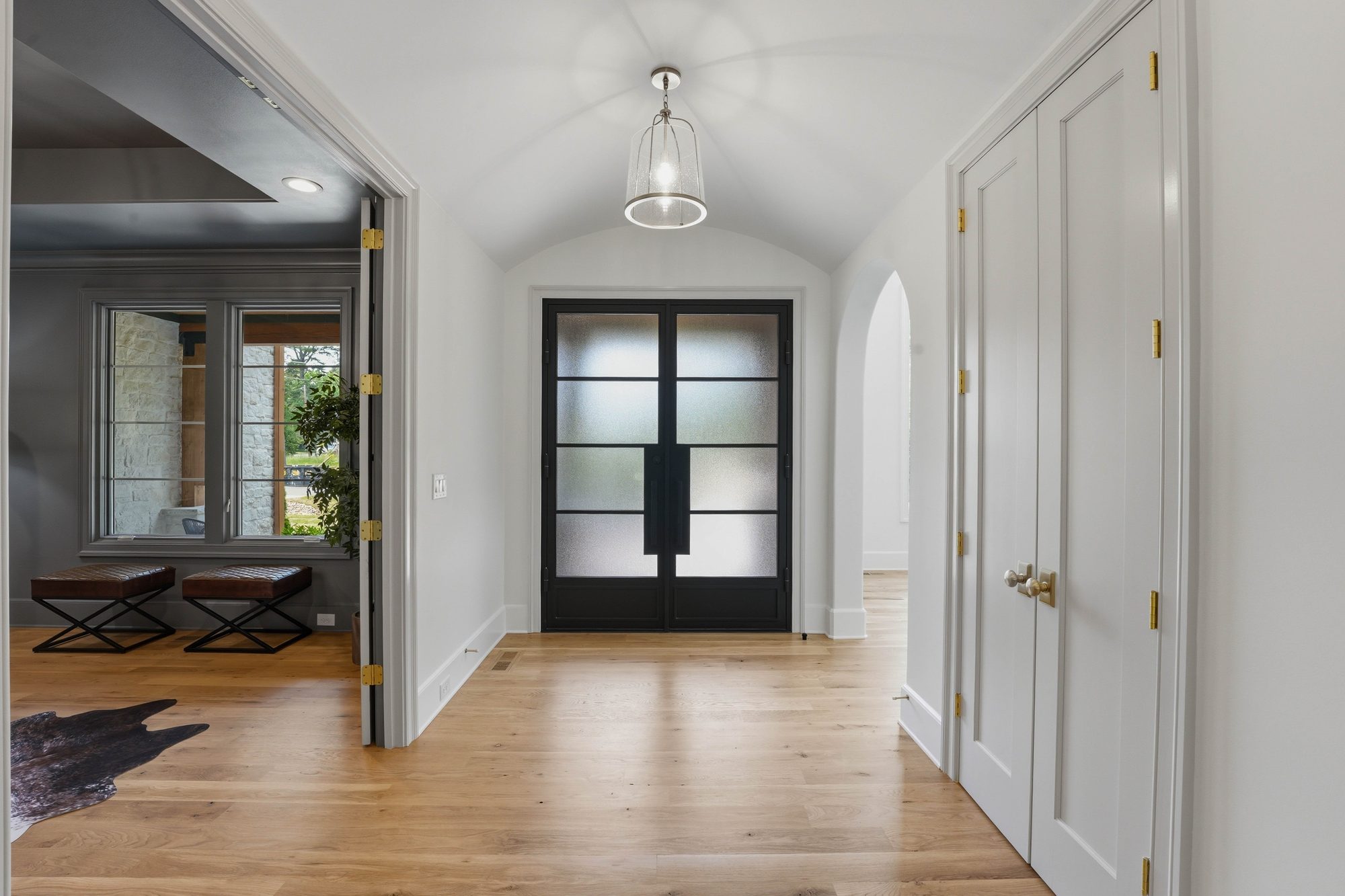 Vaulted foyer with arched ceiling and steel-and-glass double doors — Creola custom home in Charlotte NC by Stillman Properties