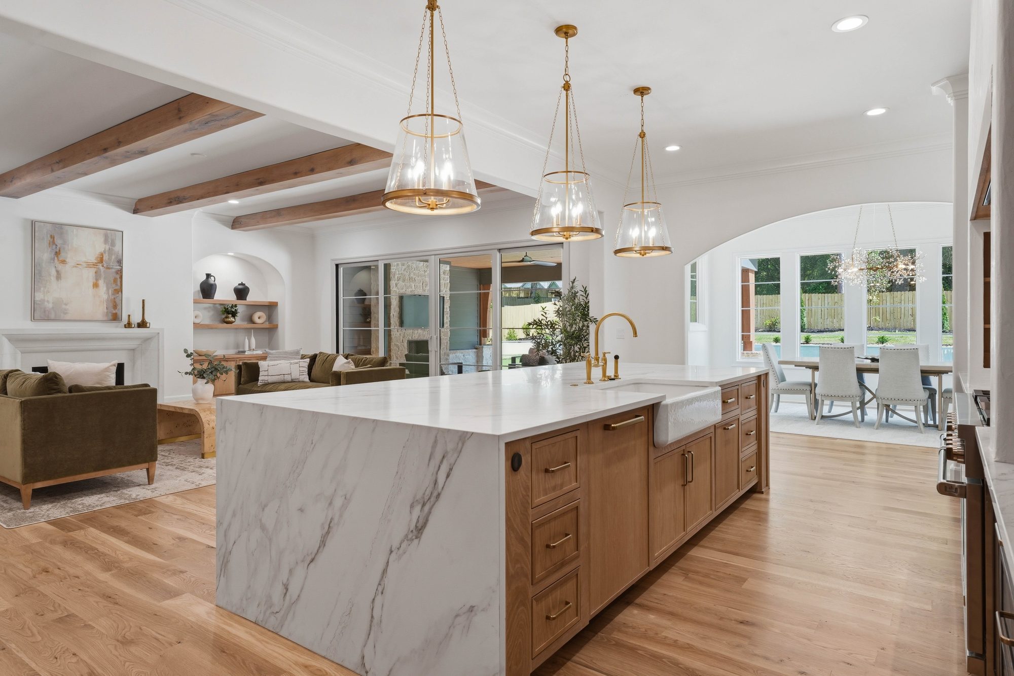 Kitchen island and stained white oak cabinetry with brass detailing — Creola custom home in Charlotte NC by Stillman Properties