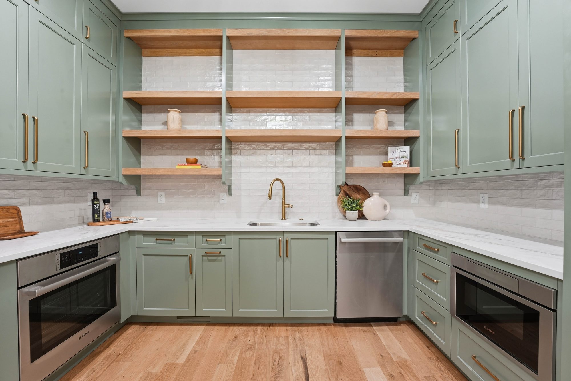 Sage green scullery with brass fixtures, open shelving, and double Bosch appliances — Creola custom home in Charlotte NC by Stillman Properties