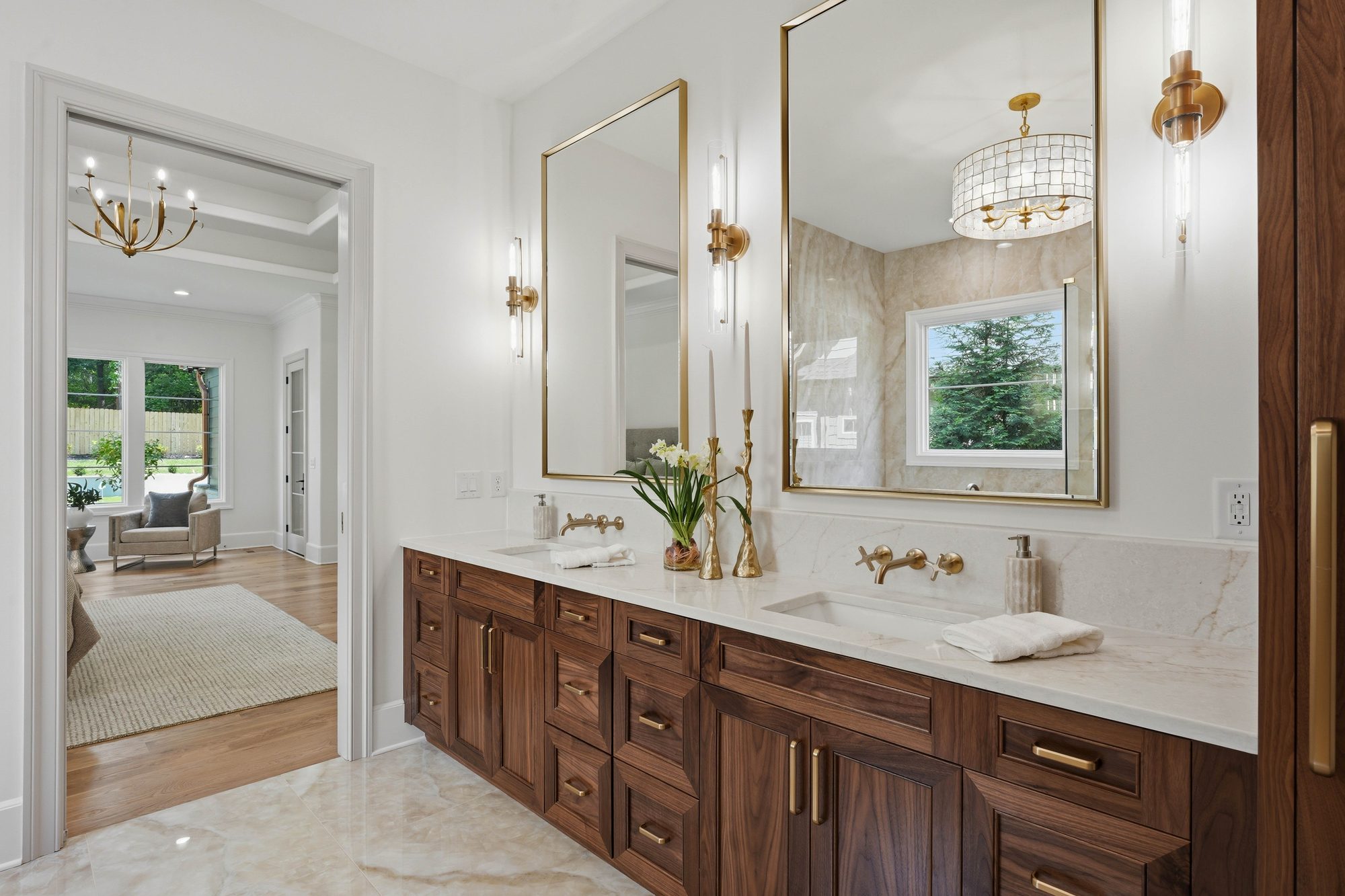 Walnut double vanity with brass cross-handle wall-mount faucets — Creola primary bath in Charlotte NC by Stillman Properties