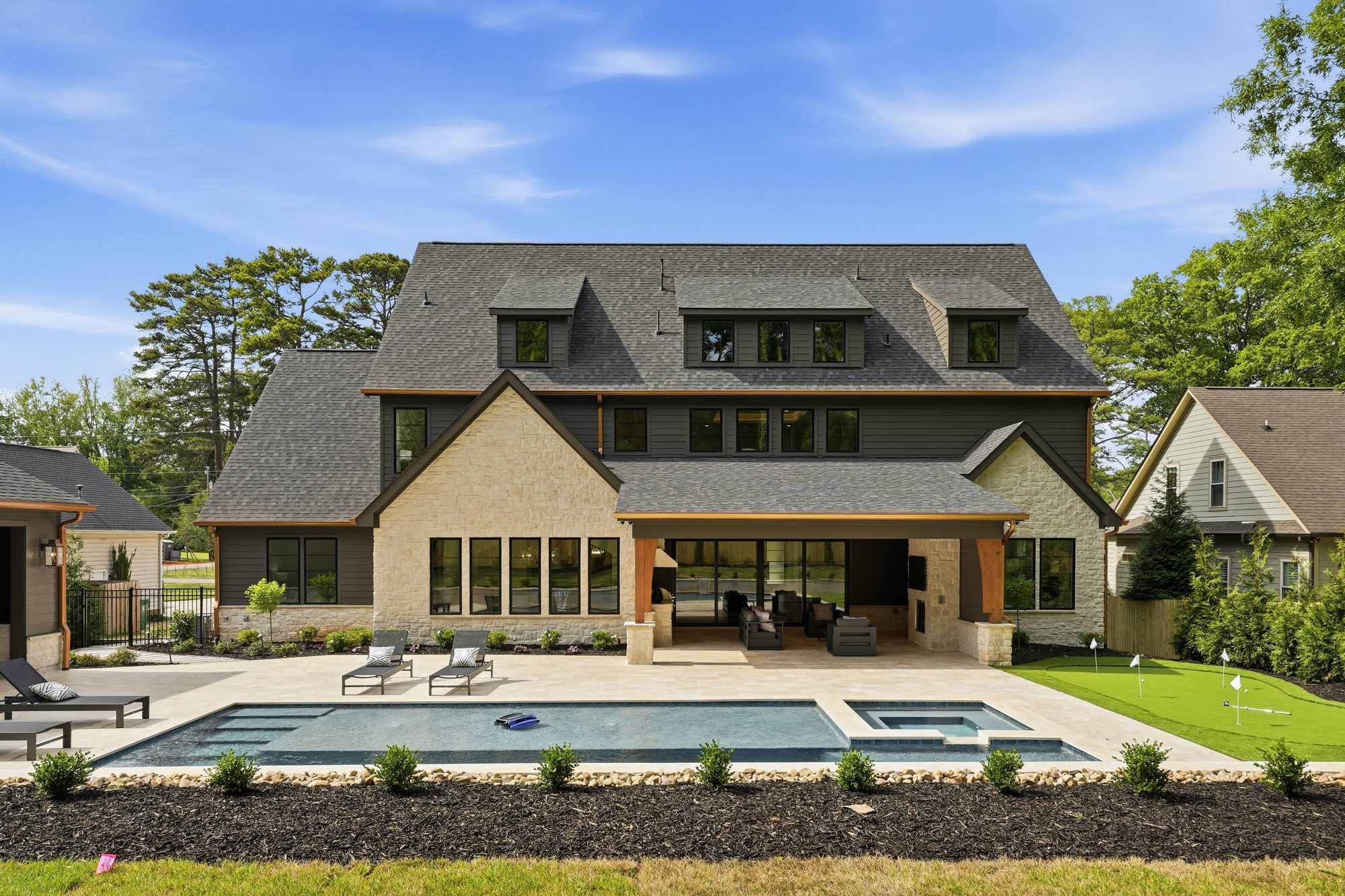 Rear elevation of Creola showing pool, spa, putting green, and covered outdoor living wing — Creola custom home in Charlotte NC by Stillman Properties