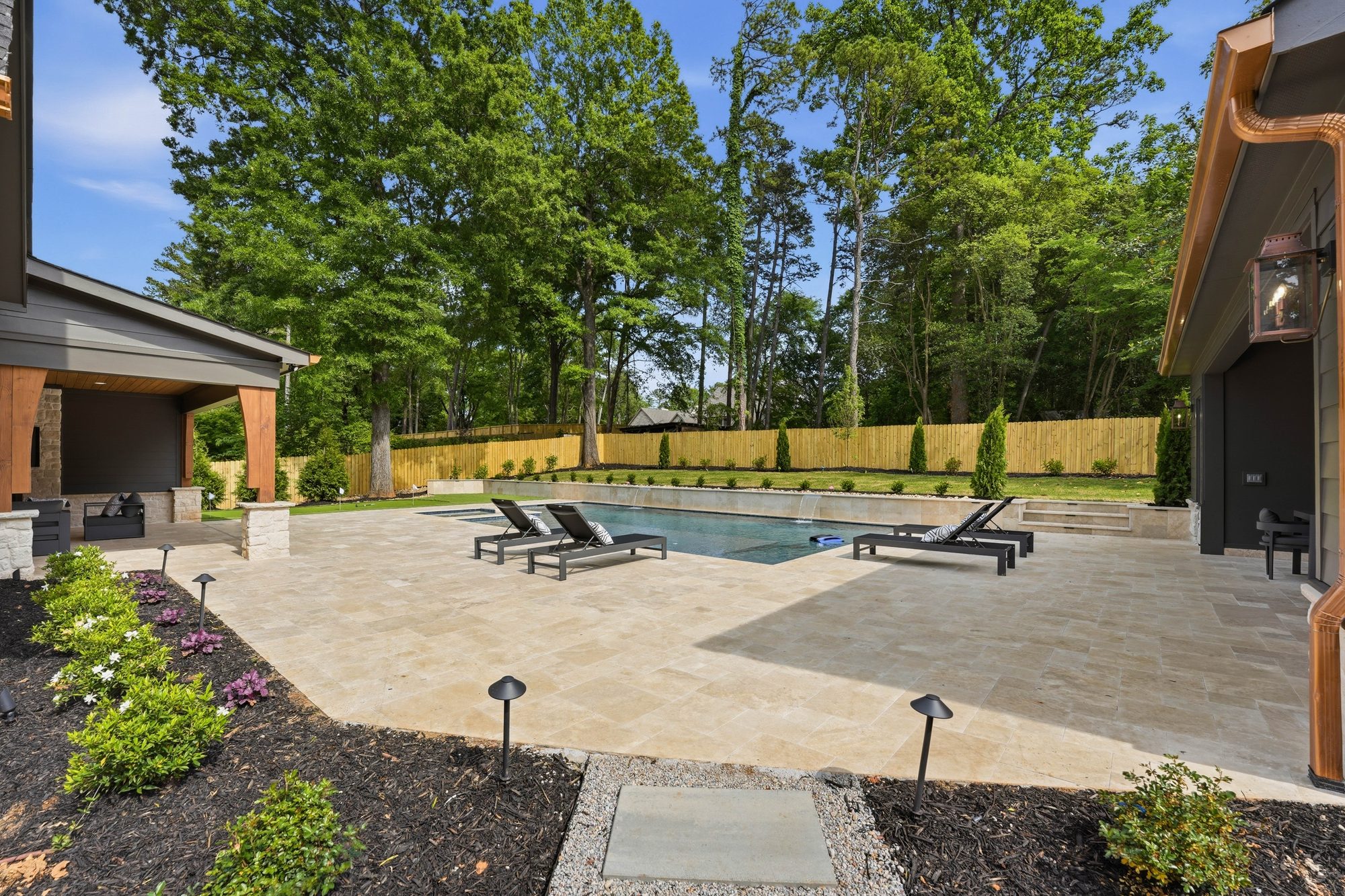 Pool and spa with sun loungers and landscaped surround — Creola custom home in Charlotte NC by Stillman Properties
