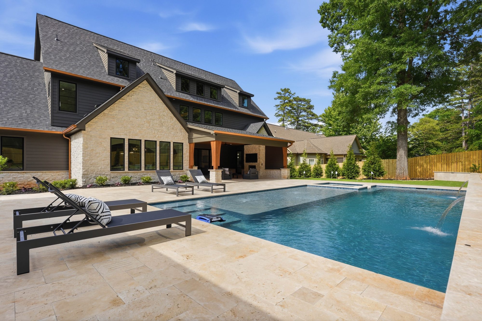 Wide rear view of Creola showing the full backyard, pool deck, and architectural elevation — Creola custom home in Charlotte NC by Stillman Properties