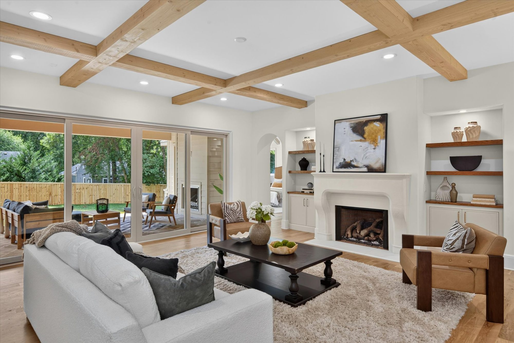 Great room at Heather with multi-panel sliding doors open to the covered porch and its outdoor fireplace — Heather by Stillman Properties Charlotte NC