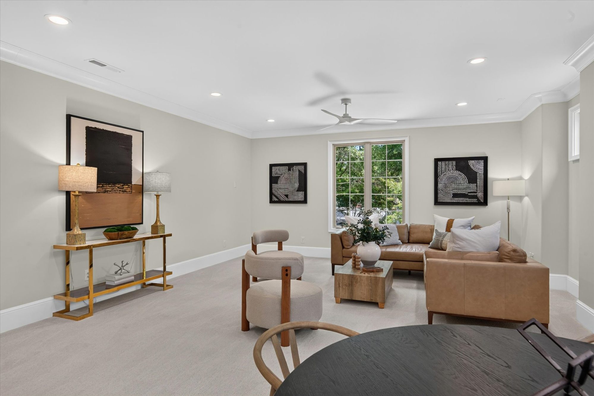 Bonus room seating area at Heather with leather sectional and crown-molded ceiling — Heather by Stillman Properties Charlotte NC