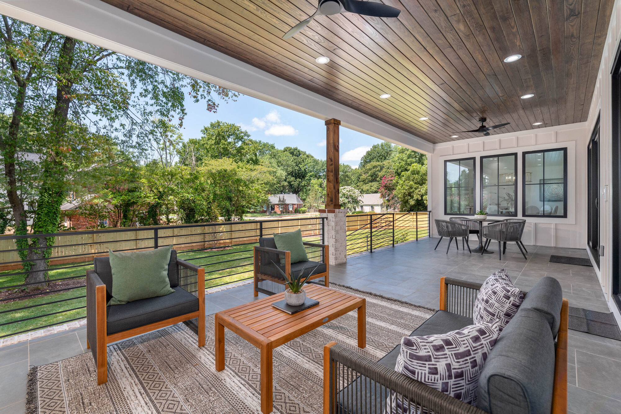 Walker covered deck wide view showing the full-length seating zones — Stillman Properties Cotswold Charlotte NC