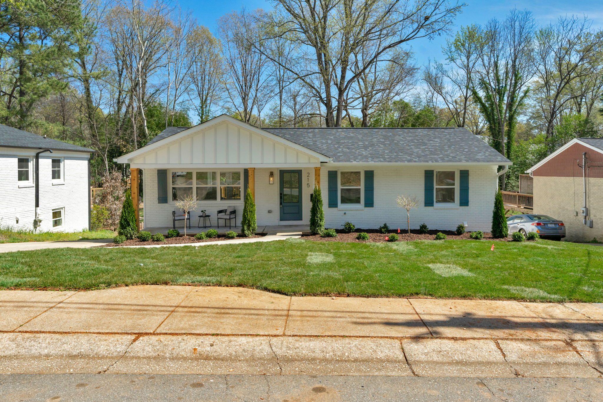 Three-quarter front view of the Wyanoke renovation showing the updated roofline and landscaping — Stillman Properties Charlotte NC