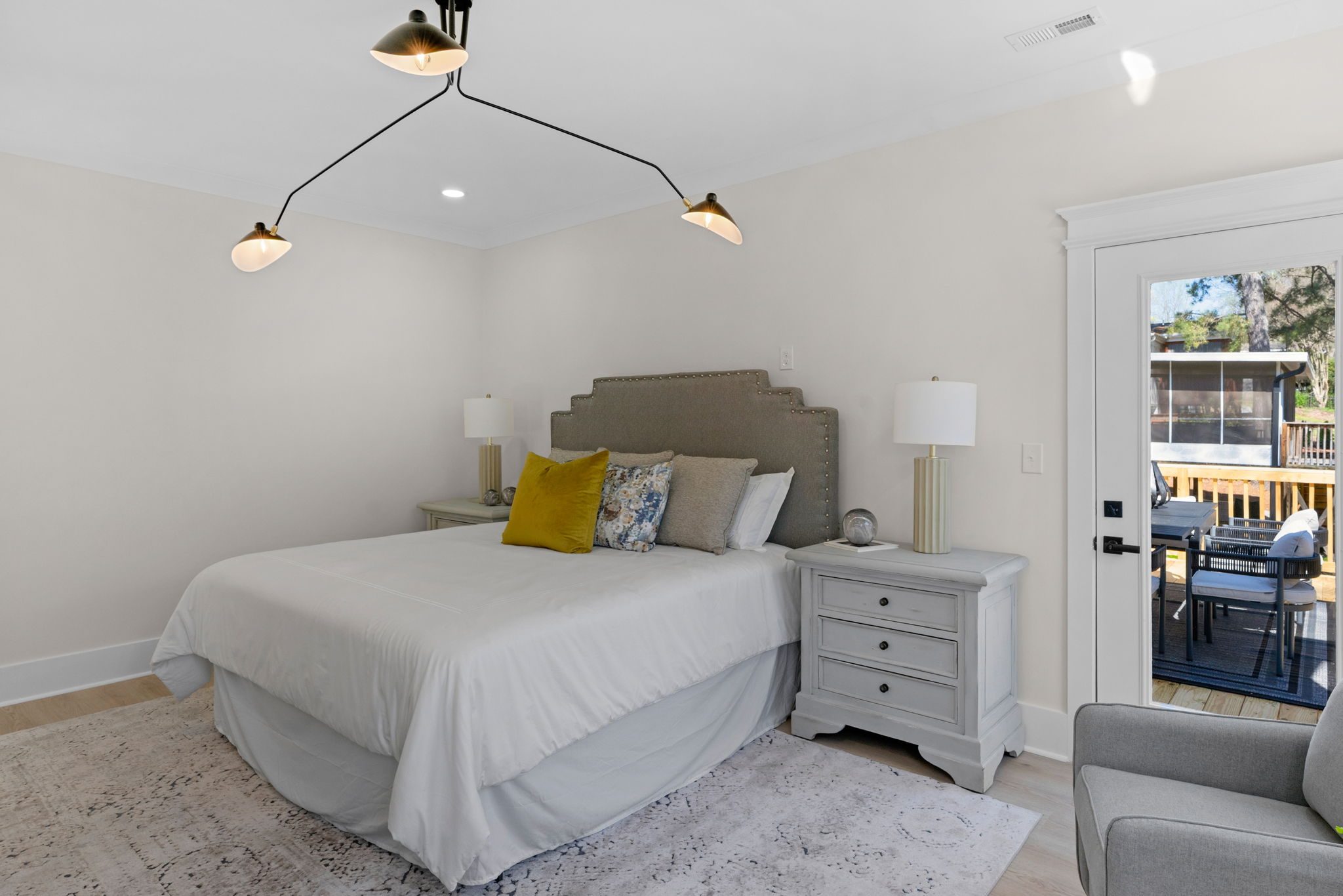 Primary bedroom from an alternate angle with access to the backyard — Wyanoke by Stillman Properties Charlotte NC