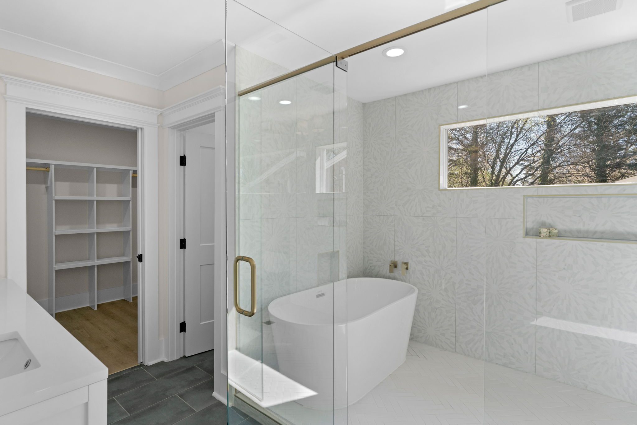 Primary bath with freestanding soaking tub and glass-enclosed shower — Wyanoke by Stillman Properties Charlotte NC