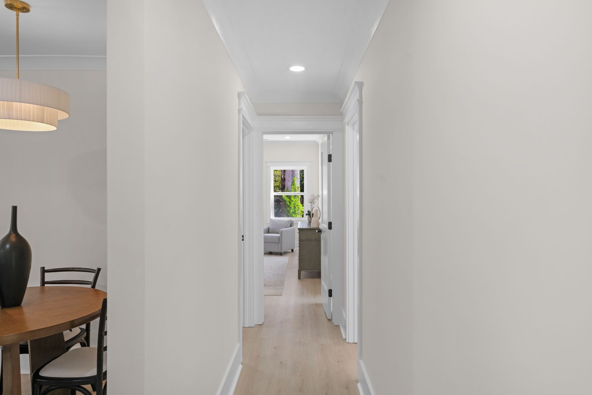 Main-level hallway with refinished flooring connecting the bedrooms — Wyanoke by Stillman Properties Charlotte NC