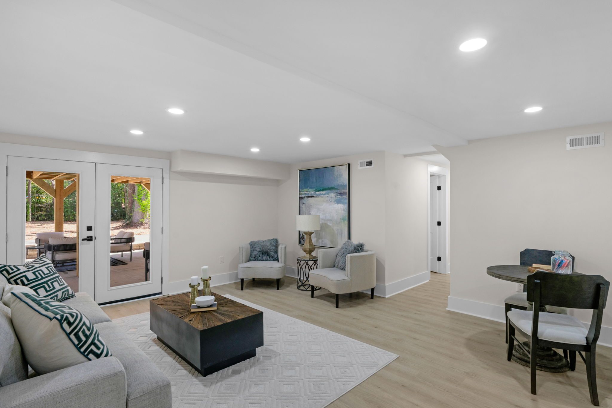 Lower-level family room from an alternate angle showing the open layout — Wyanoke by Stillman Properties Charlotte NC