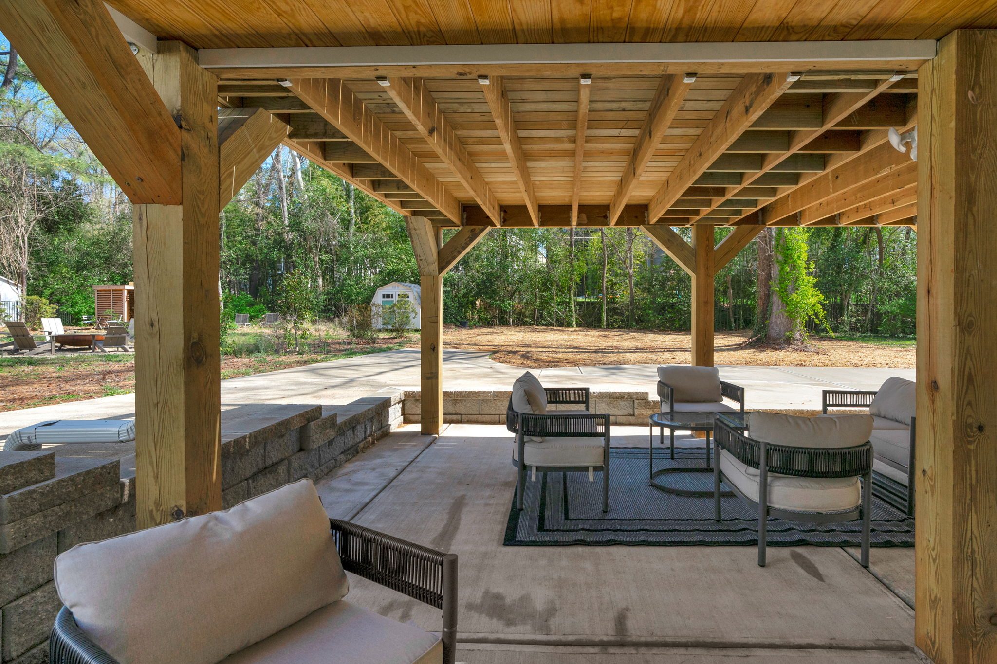 Covered outdoor pavilion with timber framing and lounge seating — Wyanoke by Stillman Properties Charlotte NC