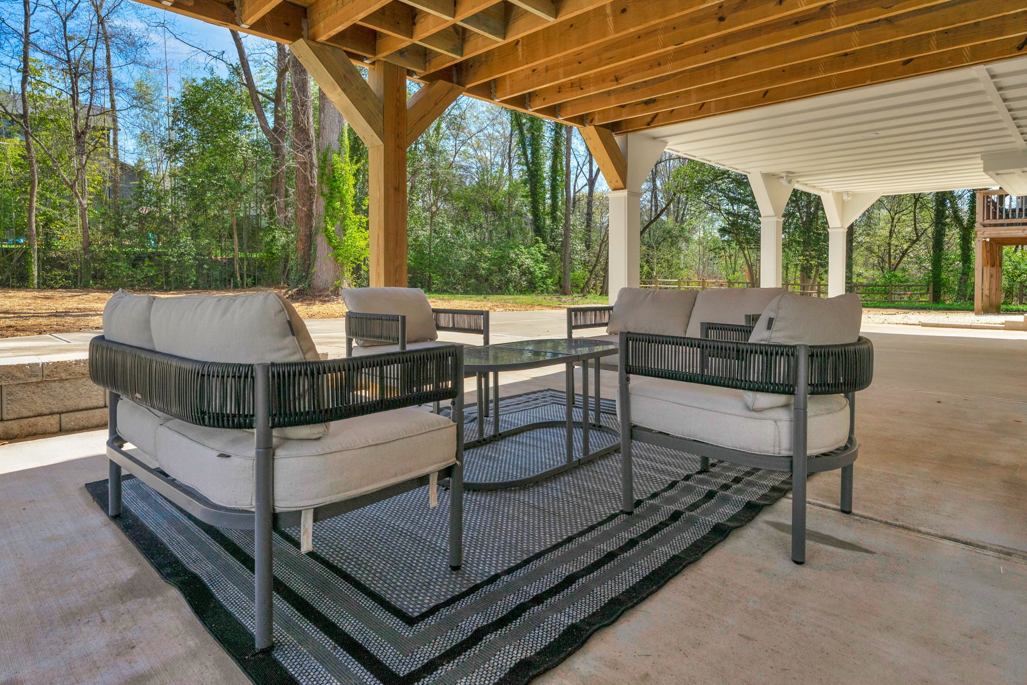 Pavilion lounge seating beneath the timber roof structure — Wyanoke by Stillman Properties Charlotte NC