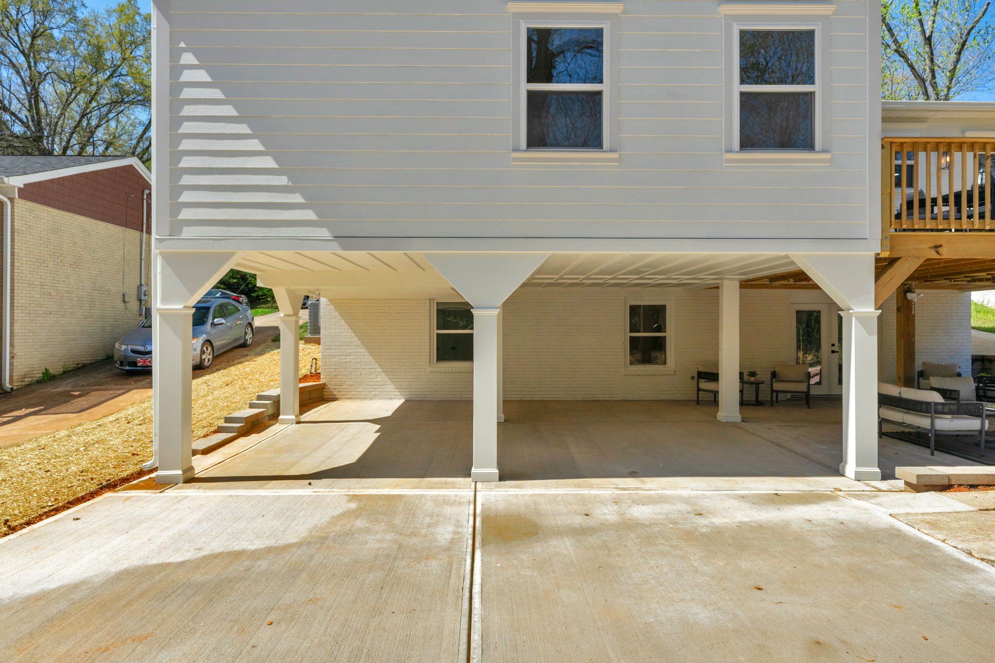 Lower-level carport and entry beneath the rear of the home — Wyanoke by Stillman Properties Charlotte NC